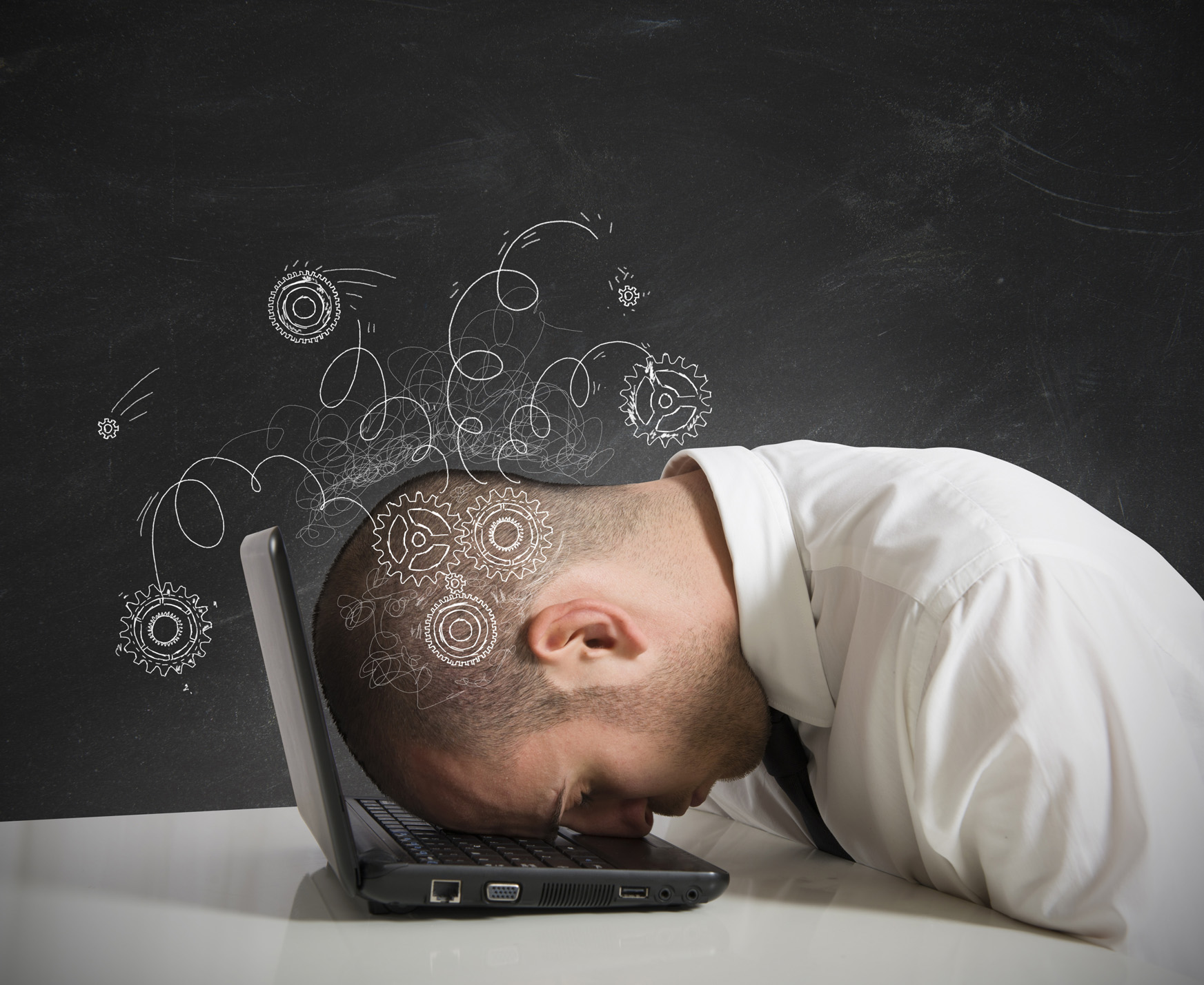 man with head on laptop